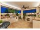Outdoor kitchen and dining space with a grill, sink, and counter space, perfect for entertaining at 7425 W Caro Rd, Glendale, AZ 85308