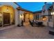 Cozy outdoor patio with a stone fireplace and comfortable seating at 7425 W Caro Rd, Glendale, AZ 85308