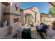 Inviting outdoor living space with a fireplace and comfortable seating, perfect for relaxing and entertaining in style at 7425 W Caro Rd, Glendale, AZ 85308