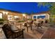 Spacious outdoor patio with seating, an outdoor kitchen, and a built-in fireplace at 7425 W Caro Rd, Glendale, AZ 85308