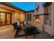 Covered patio features an outdoor fireplace, ample seating and a beautifully bricked floor at 7425 W Caro Rd, Glendale, AZ 85308