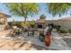Outdoor patio features outdoor furniture, a fireplace, and mature trees at 7425 W Caro Rd, Glendale, AZ 85308
