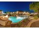 Backyard view of a luxurious pool with fire bowls, a water feature, and a covered patio at 7425 W Caro Rd, Glendale, AZ 85308