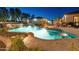 Sparkling pool with water features and a tanning ledge surrounded by lush landscaping at 7425 W Caro Rd, Glendale, AZ 85308