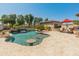 Inviting pool with bar and waterfall feature, complemented by outdoor seating and desert landscaping at 7425 W Caro Rd, Glendale, AZ 85308
