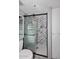 Walk in shower with gray tile walls and a white hexagon tile floor, and grab bars at 7950 E Camelback Rd # 308, Scottsdale, AZ 85251