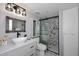 Bathroom features a new sink, unique mirror and a walk in shower with gray tile at 7950 E Camelback Rd # 308, Scottsdale, AZ 85251