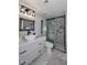 Bathroom features a new sink, unique mirror and a walk in shower with gray tile at 7950 E Camelback Rd # 308, Scottsdale, AZ 85251