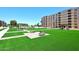 Beautiful condo complex common area with green grass, shaded benches and attractive landscaping at 7950 E Camelback Rd # 308, Scottsdale, AZ 85251