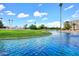 Beautifully landscaped golf course with a scenic pond and blue skies, perfect for an active lifestyle at 7950 E Camelback Rd # 308, Scottsdale, AZ 85251