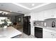 Stylish kitchen with stainless steel appliances, white cabinets, and a gray tile backsplash at 7950 E Camelback Rd # 308, Scottsdale, AZ 85251