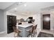 Modern kitchen with stainless steel appliances, center island with chairs, and white cabinets at 7950 E Camelback Rd # 308, Scottsdale, AZ 85251