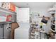 Cozy laundry room with washer, dryer, shelving with supplies, and an ironing board at 7950 E Camelback Rd # 308, Scottsdale, AZ 85251