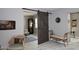 Cozy living area with an open layout, a decorative barn door, and stylish seating arrangements at 7950 E Camelback Rd # 308, Scottsdale, AZ 85251