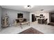 Open-concept living area with a modern kitchen featuring stainless steel appliances and a breakfast bar at 7950 E Camelback Rd # 308, Scottsdale, AZ 85251