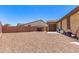 Large backyard featuring gravel, potential for customization, and access to the garage and neighboring properties at 8418 W Palmaire Ave, Glendale, AZ 85305