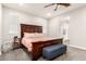 The bedroom features a beautiful wooden bed frame, complemented by a blue bench at 8418 W Palmaire Ave, Glendale, AZ 85305
