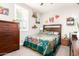 The bedroom features bright decor and colorful wall art, complemented by light gray walls at 8418 W Palmaire Ave, Glendale, AZ 85305