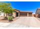 Charming single-story home featuring a three-car garage and tile roof, complemented by low-maintenance desert landscaping at 8418 W Palmaire Ave, Glendale, AZ 85305