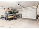 Spacious two car garage featuring ample storage space and a bright white garage door at 8418 W Palmaire Ave, Glendale, AZ 85305