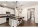 Bright kitchen with white cabinets, dark countertops, a central island, and stainless steel appliances at 8418 W Palmaire Ave, Glendale, AZ 85305