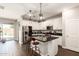Modern kitchen with white cabinets, dark countertops, stainless steel appliances, and a breakfast bar at 8418 W Palmaire Ave, Glendale, AZ 85305
