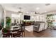 Combined living and dining area featuring a table set, plush seating, and a view of the outdoor pool at 8418 W Palmaire Ave, Glendale, AZ 85305