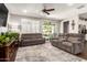 Cozy living room with dual couches, a large window with shutters, and a view to the outdoor patio at 8418 W Palmaire Ave, Glendale, AZ 85305