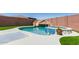 Inviting backyard pool featuring rock slide and jacuzzi, surrounded by artificial turf at 8418 W Palmaire Ave, Glendale, AZ 85305