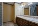 Well-lit bathroom features a dual sink vanity with wooden cabinets and decorative tile accents at 8637 E Appaloosa Trl, Scottsdale, AZ 85258