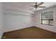 Bedroom featuring a ceiling fan, carpet floors, a window and closet at 8637 E Appaloosa Trl, Scottsdale, AZ 85258