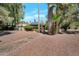 Charming exterior of a home featuring desert landscaping, mature trees, and solar panels on the roof at 8637 E Appaloosa Trl, Scottsdale, AZ 85258