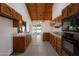 Traditional kitchen featuring oak cabinets, tile countertops, tile flooring, and wood-beam vaulted ceiling at 8637 E Appaloosa Trl, Scottsdale, AZ 85258