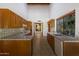 Spacious kitchen featuring oak cabinets, tile countertops, tile flooring, and view of entry at 8637 E Appaloosa Trl, Scottsdale, AZ 85258
