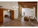 Bright living space with tile floors, wood-beam ceilings, fireplace and an adjacent kitchen at 8637 E Appaloosa Trl, Scottsdale, AZ 85258