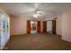 Main bedroom featuring a ceiling fan, carpet floors, and doors to closet and bathroom at 8637 E Appaloosa Trl, Scottsdale, AZ 85258