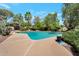 Backyard pool surrounded by lush greenery and mature trees offers a private oasis for relaxation and enjoyment at 8637 E Appaloosa Trl, Scottsdale, AZ 85258