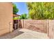 Backyard with gravel and a brick wall and a covered patio with a newly installed AC unit at 921 W University Dr # 1023, Mesa, AZ 85201