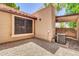 Backyard with gravel and a covered patio and a newly installed AC unit at 921 W University Dr # 1023, Mesa, AZ 85201