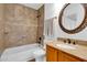 Well-lit bathroom featuring granite counters, an oval mirror, and a tiled shower-over-tub at 921 W University Dr # 1023, Mesa, AZ 85201