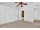 Bedroom featuring neutral carpet with an attached bathroom, sliding closet doors, and access to other rooms at 921 W University Dr # 1023, Mesa, AZ 85201