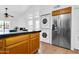 Open kitchen featuring a breakfast bar, stainless steel refrigerator, and adjacent washer and dryer at 921 W University Dr # 1023, Mesa, AZ 85201