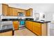 Kitchen featuring wood cabinetry, tile floors, granite counters, and stainless steel appliances at 921 W University Dr # 1023, Mesa, AZ 85201