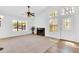 Bright living room featuring large windows, neutral carpet, and a cozy fireplace at 921 W University Dr # 1023, Mesa, AZ 85201
