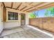 Covered patio with concrete pavers, a brick wall, and a view of the yard through a wrought iron door at 921 W University Dr # 1023, Mesa, AZ 85201