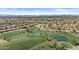 Stunning aerial view of the community showcasing lush golf courses and pristine lakes at 9826 W Tonto Ln, Peoria, AZ 85382