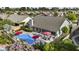 A beautiful backyard pool featuring lush landscaping, patio furniture, and vibrant pink umbrellas for relaxing outdoors at 9826 W Tonto Ln, Peoria, AZ 85382