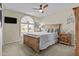 Cozy bedroom features a wooden bed frame and arched window that fills the room with soft, natural light at 9826 W Tonto Ln, Peoria, AZ 85382