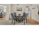 Cozy dining area features a modern glass table and comfortable upholstered chairs at 9826 W Tonto Ln, Peoria, AZ 85382