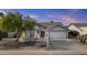 Charming single-story home features a well-maintained yard and inviting front porch at 9826 W Tonto Ln, Peoria, AZ 85382
